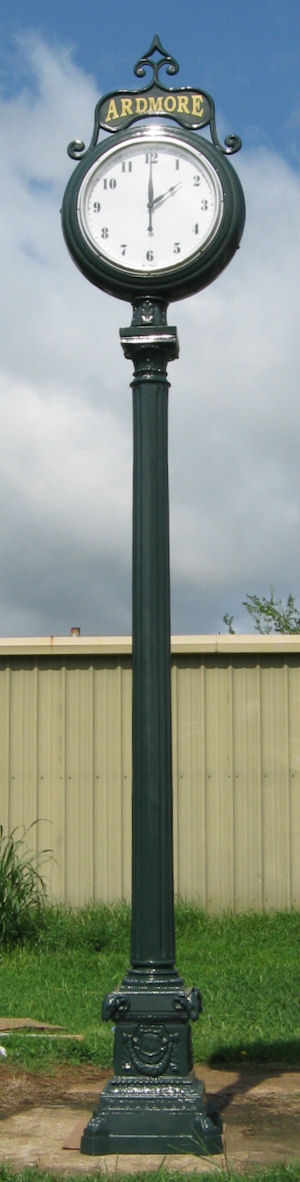 tall presidential street clock with hunter green finish and lettered signage